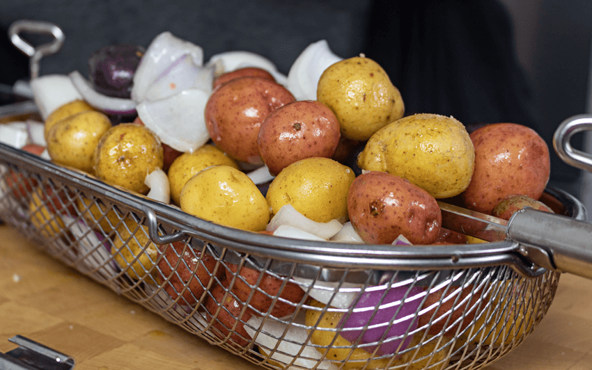 Prepare the potatoes and onions in the Rotisserie Grill Basket