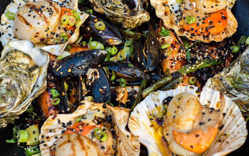 Recipe image of Sichuan And Sesame Spiced Shellfish Platter With Green Beans And Grilled Cabbage