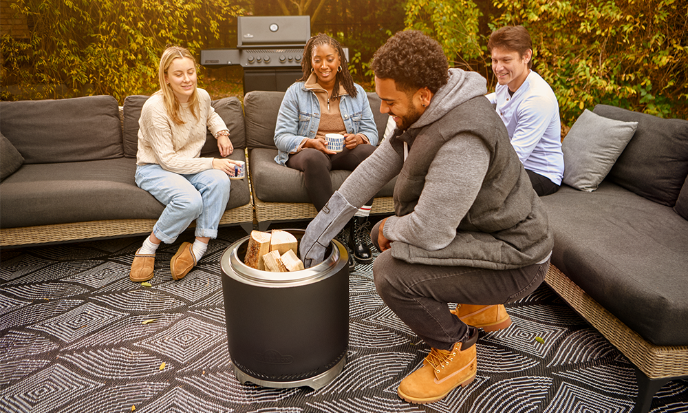 Timberwolf firepit with logs being put into it